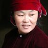 Close-up portrait of a woman in traditional red attire from Hà Giang, Vietnam.
